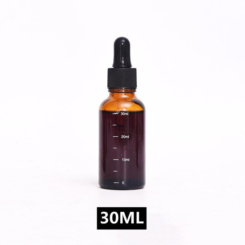 May include: A 30 ml amber glass bottle with a black dropper top. The bottle has a clear graduated scale with markings for 10 ml, 20 ml, and 30 ml.