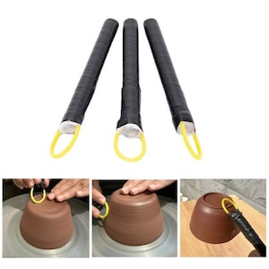 May include: Three black pottery tools with yellow rubber rings at the end. The tools are used to shape pottery on a pottery wheel. The tools are shown being used to shape a brown clay pot.