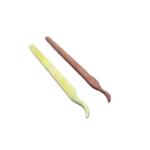 May include: Two sculpting tools for clay modeling. One tool is light yellow and the other is brown. Both tools feature a long, straight handle that tapers into a curved, pointed tip. The tools are positioned diagonally against a white background.