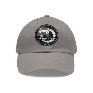 May include: Gray baseball cap with a black and white patch featuring a silhouette of a car and the text "4Runner Gear".