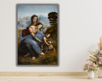May include: A rectangular wall art print featuring a reproduction of The Virgin and Child with Saint Anne. The painting depicts three figures and a lamb in a landscape with mountains and a tree, rendered in muted blue, brown, and green tones.