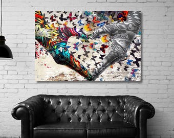 May include: A rectangular wall art print featuring two hands forming a heart shape. The left hand is decorated with vibrant, multi-colored abstract patterns, while the right hand is rendered in grayscale. Numerous colorful butterflies surround the hands.