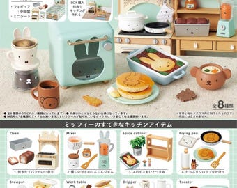 May include: A set of eight miniature kitchen items featuring a light blue oven, a white mixer, a wooden spice cabinet, a brown frying pan, a brown stew pot, a wooden work table, a white coffee dripper, and a light blue toaster. Each item features a small bunny rabbit design. The set is part of a larger collection called "Miffy's Natural Kitchen".