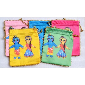 May include: Six colorful drawstring bags with a gold trim. Each bag features a printed image of a cartoon couple dressed in traditional Indian clothing.