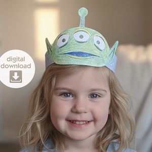 May include: A child wearing a green and blue alien-themed paper crown with three eyes and antennae. The crown is a digital download, as indicated by the text and icon in the image.