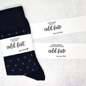 May include: A pair of dark blue socks with white polka dots and a white tag that reads "Just in case you get cold feet. Love, your bride".
