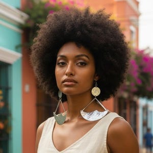 May include: Large, dangling earrings featuring a silver-toned, hammered metal finish. The design consists of a small circular top piece connected to a larger, triangular frame that supports a curved, textured base element with a distinct wave-like edge.