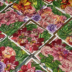 May include: A collection of floral embroidered patches. Each patch features a unique arrangement of colorful flowers, including roses, orchids, and other blooms, with green leaves. The patches are set against a white background.