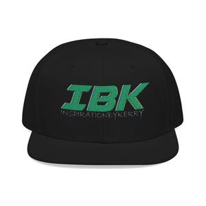 May include: Black baseball cap with a flat brim, featuring the embroidered green text "IBK" and the words "INSPIRATIONBYKERR" underneath. The cap has a structured design and a flat peak.