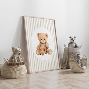 May include: A framed print featuring a watercolor illustration of a teddy bear holding a wooden train. The print has a beige and white striped background. Woven baskets with stuffed animals, including a dog, panda, and zebra, are in the foreground.