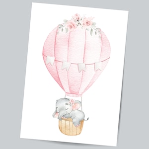 May include: A watercolor illustration of a pink hot air balloon with a gray elephant sleeping inside. The balloon is decorated with white flags and a floral garland of pink and white flowers.