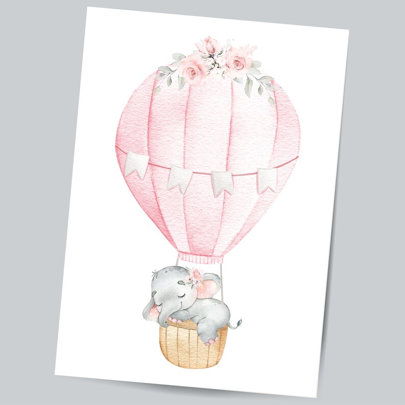 May include: A watercolor illustration of a pink hot air balloon with a gray elephant sleeping inside. The balloon is decorated with white flags and a floral garland of pink and white flowers.