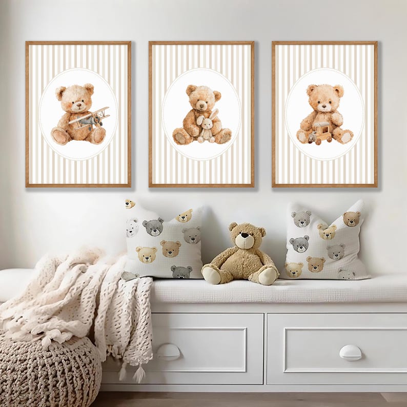 May include: Three framed prints featuring watercolor teddy bears with toys, set against a striped background. The prints are in wooden frames. Pillows with teddy bear patterns and a stuffed teddy bear are also visible.