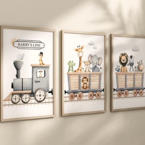 May include: Set of three framed art prints featuring watercolor illustrations of a train and animal characters. The first print shows a train with the text "HARRY'S LINE". The other prints depict animals in train cars, including a giraffe, lion, and elephant.