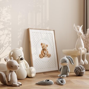 May include: A framed print featuring a watercolor illustration of a teddy bear holding a smaller stuffed animal. The image is surrounded by plush toys, including a white bear, a gray squirrel, and a gray bunny. Decorative items include a white rabbit figurine and a gray knot.