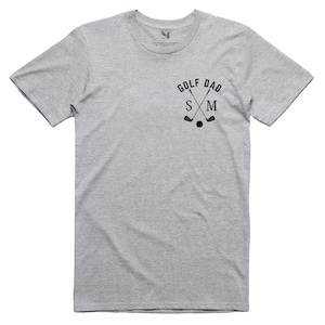 May include: Grey short-sleeved t-shirt with the text "GOLF DAD" and crossed golf clubs with the letters "S" and "M" in the centre.