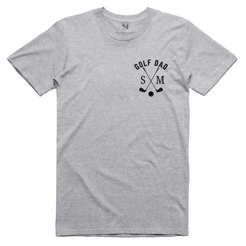 May include: Grey short-sleeved t-shirt with the text "GOLF DAD" and crossed golf clubs with the letters "S" and "M" in the centre.