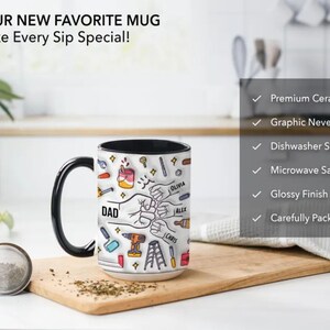 May include: A white ceramic mug with a black handle and interior, featuring a graphic of tools, fists, and the word "DAD." The mug also includes the text "YOUR NEW FAVORITE MUG Make Every Sip Special!" and names like "Olivia" and "Alex."