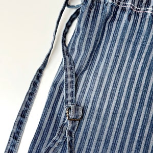 frayed jeans small backpack - view close up of adjustable drawstrings