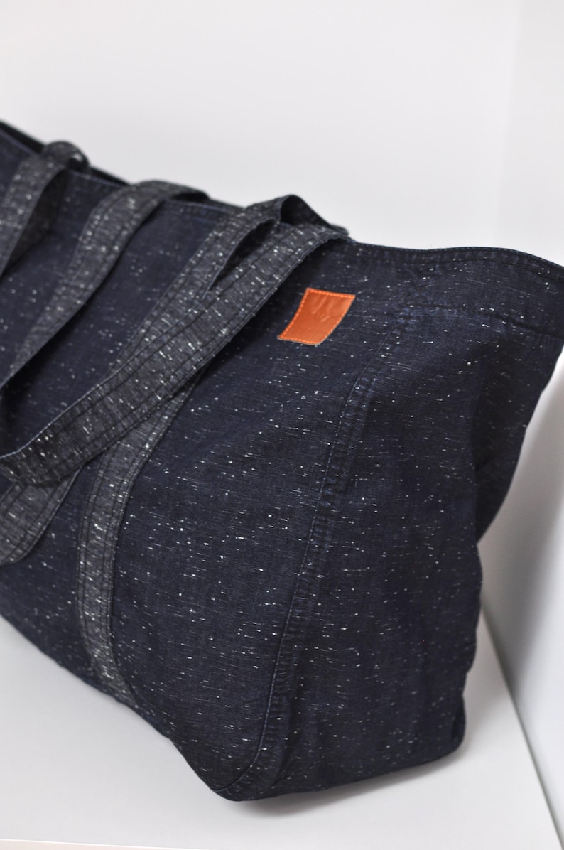 Big market bag of lightweight fabric, Extra large grocery bag, Denim high capacity shopper, Reusable oversize tote for sustainable shopping - side view of high capacity