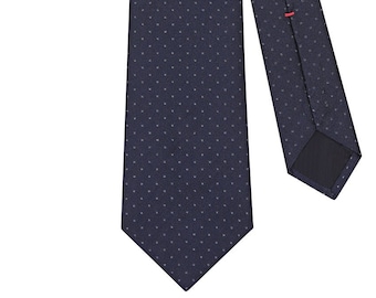 May include: Navy blue tie with a subtle dotted pattern. The tie is made of a textured fabric and features a classic pointed end. A small red accent is visible on the back of the tie, adding a touch of color. This tie is suitable for formal or business attire.