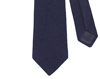 May include: A dark blue silk tie with a textured pattern.