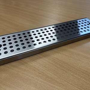 Puede incluir: Un juego de tres tazas de cerámica con un esmalte moteado de color crema. Cada taza presenta un diseño pintado a mano diferente: una hoja azul y verde, una flor amarilla y una baya roja. Las tazas tienen un diseño simple y moderno.