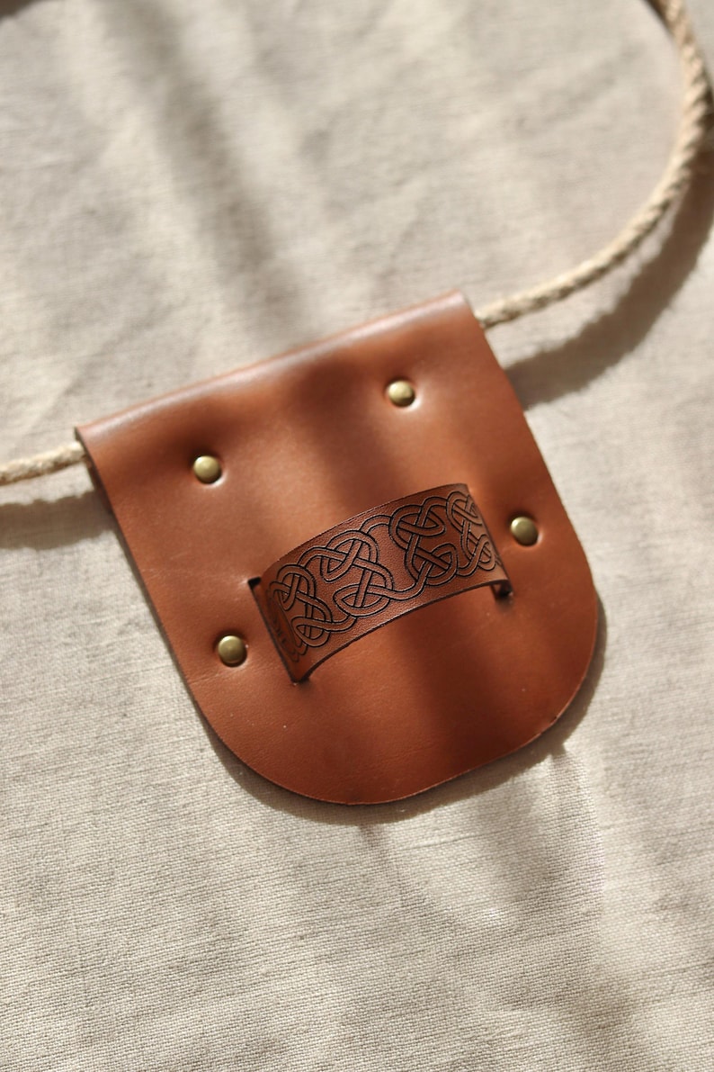 Brown leather sheath scabbard for wooden sword.