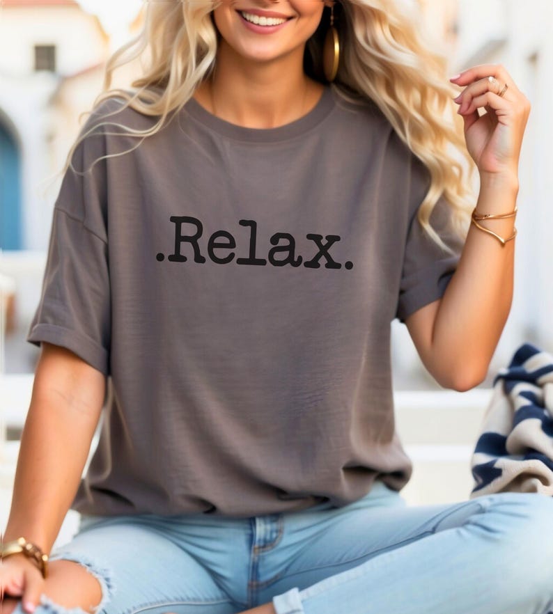 May include: A grey t-shirt with the word "Relax." printed in black on the front.