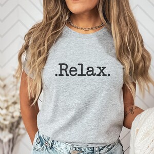 May include: A grey t-shirt with the text ".Relax." printed in black.