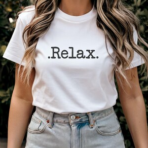 May include: White t-shirt with the text "Relax." printed in black.