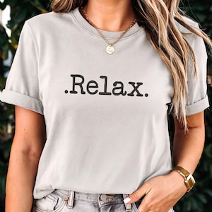 May include: A light grey t-shirt with the text ".Relax." printed in black.