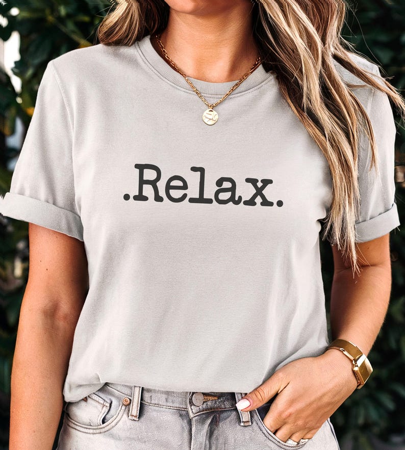 May include: A light grey t-shirt with the text ".Relax." printed in black.