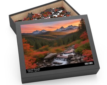 May include: A 500 piece jigsaw puzzle featuring a scenic mountain landscape with a cascading waterfall. The puzzle box shows a vibrant sunset over the mountains with a stream flowing through a forest of red and green trees. The box reads "16x20 Puzzle 500 pcs Ages 9+ "