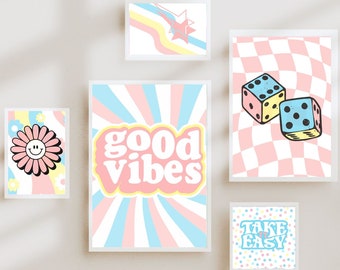 May include: Five framed prints with a retro aesthetic. The prints feature a smiley face flower, the words "good vibes" in a pink and blue sunburst pattern, two dice on a pink and white chequered background, and the words "take it easy" on a pink and blue polka dot background.