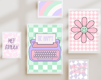 May include: Five framed prints with a pastel colour scheme. The prints feature a typewriter with the text "BE HAPPY", a daisy with a smiley face, a checkered pattern with the text "HEY QUEEN", a checkered pattern with the text "SLAY THE DAY", and a rainbow pattern.