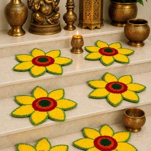 May include: Six flower-shaped tufted mats featuring yellow petals, a red inner ring, and a dark green centre. The mats are arranged on tiered steps alongside various brass decorative items, including a Ganesha statue, a lantern, and vases.