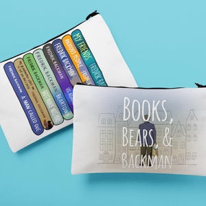 May include: Two white zippered pouches with black zippers. One pouch features a stack of book titles by Fredrik Backman. The other pouch has the text "BOOKS, BEARS & BACKMAN" with an illustration of a person.