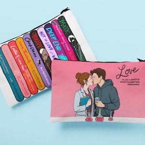 May include: Two white zippered pouches. One features colorful book spines with titles like "Deep End" and "Bride." The other has a pink background with a kissing couple illustration and the word "Love." The text reads "Love is just a bunch of neurotransmitters misbehaving."