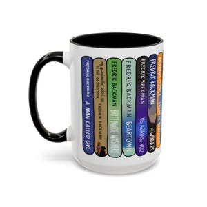 May include: A white ceramic mug with a black handle and interior. The mug features a design of book spines with titles by Fredrik Backman, including "A Man Called Ove" and "Anxious People".