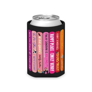 May include: A black neoprene can cooler with a design of six popular book covers. The book titles are "With You Forever", "The No-Show", "The Dead Romantics", "Finlay Donovan Is Killing It", "Happy Place", "Yours Truly".