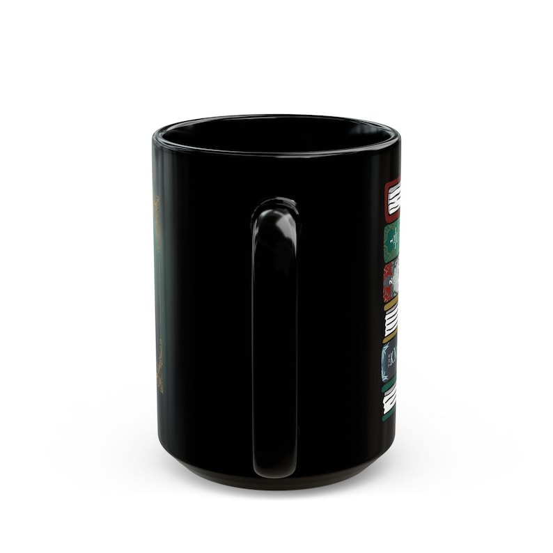 May include: Black ceramic mug with a large handle. The mug features a design of stacked books with text and colorful accents. The design is on the side of the mug, and the mug is set against a white background.