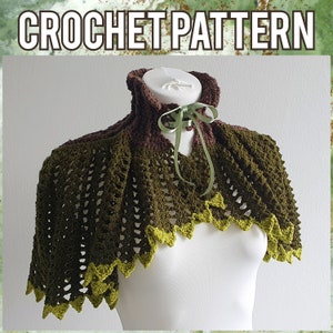 May include: A crocheted green and brown shawl with a green satin ribbon tied around the neck. The shawl has a scalloped edge and is made with a delicate stitch pattern.
