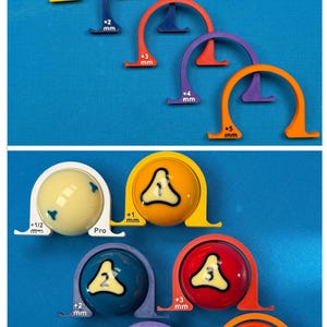 May include: A collection of billiard ball measuring tools in various colors, including white, yellow, blue, red, purple, and orange. Each tool is labeled with a millimeter measurement and a number from 1 to 5. The balls are also numbered.