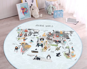 May include: A round, blue and white rug with a world map design featuring various animals from different continents. The rug has the text "ANIMAL WORLD" at the top.