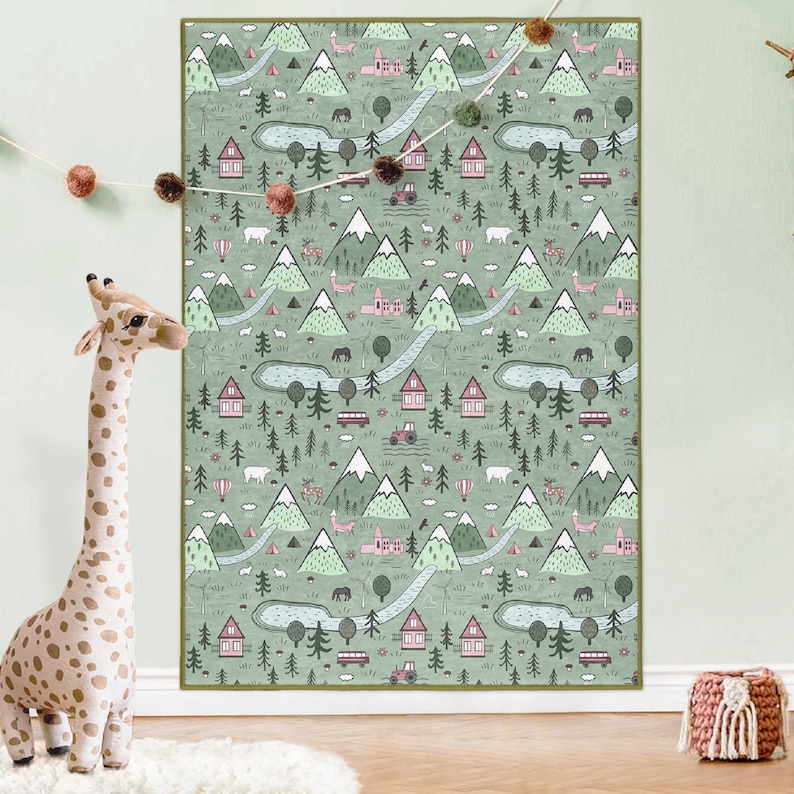 May include: A green and pink illustrated children's rug with a repeating pattern of mountains, trees, houses, and animals.