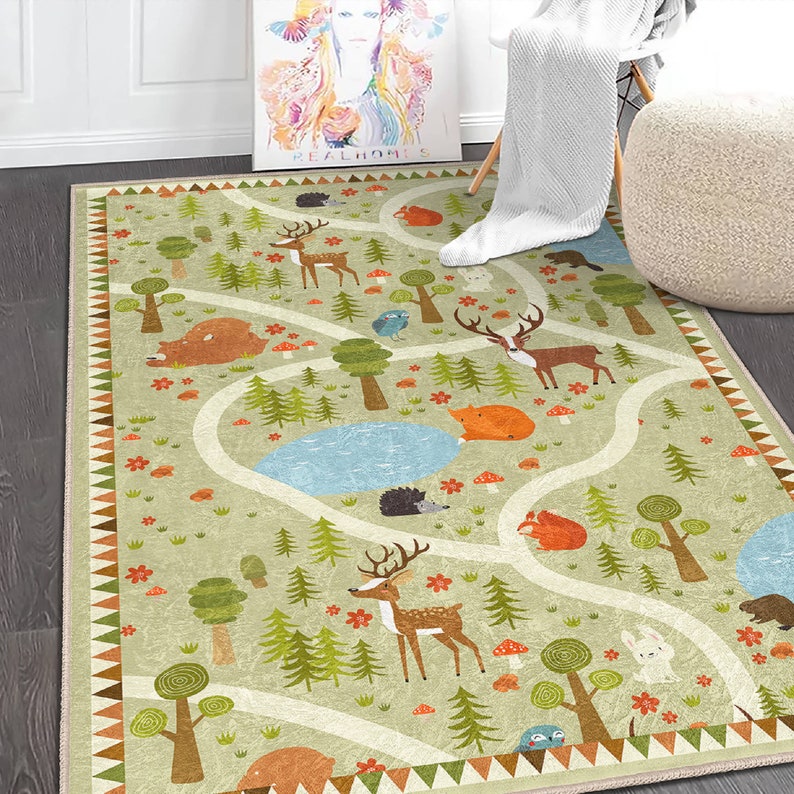 Puede incluir: Una alfombra verde y marr&oacute;n con un tema de bosque. La alfombra presenta un camino sinuoso con ciervos, zorros, osos, p&aacute;jaros y setas. La alfombra tiene un borde blanco con un ribete marr&oacute;n y naranja.