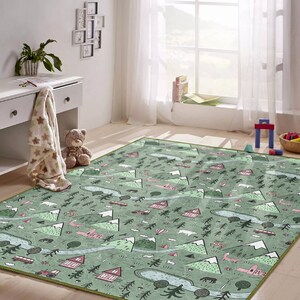 May include: A green and pink play rug with a repeating pattern of mountains, trees, houses, and animals. The rug is perfect for a child's playroom or bedroom.