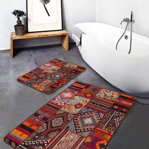 May include: Two bath mats with a patchwork design featuring geometric patterns in shades of red, orange, brown, and blue. The mats are made of a soft, absorbent material and are perfect for adding a touch of style to any bathroom.
