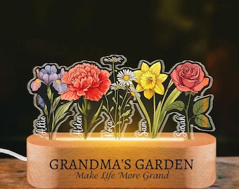 May include: A wooden night light with a personalized message "Grandma's Garden - Make Life More Grand". The light features a design of six flowers with names Allie, Helen, Rosa, Sam, and Sarah.